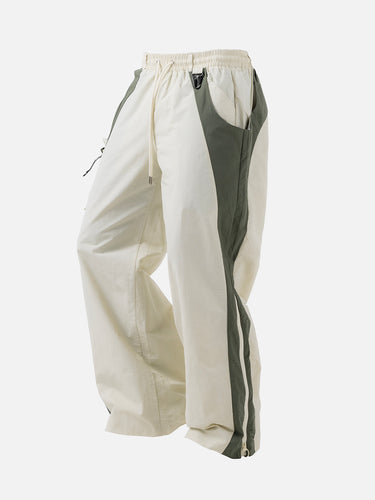 Ivory W2 Trackpants, 45-degree bent-leg side view