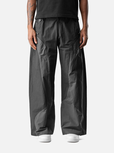 Black W7 Trackpants, front half-body on model