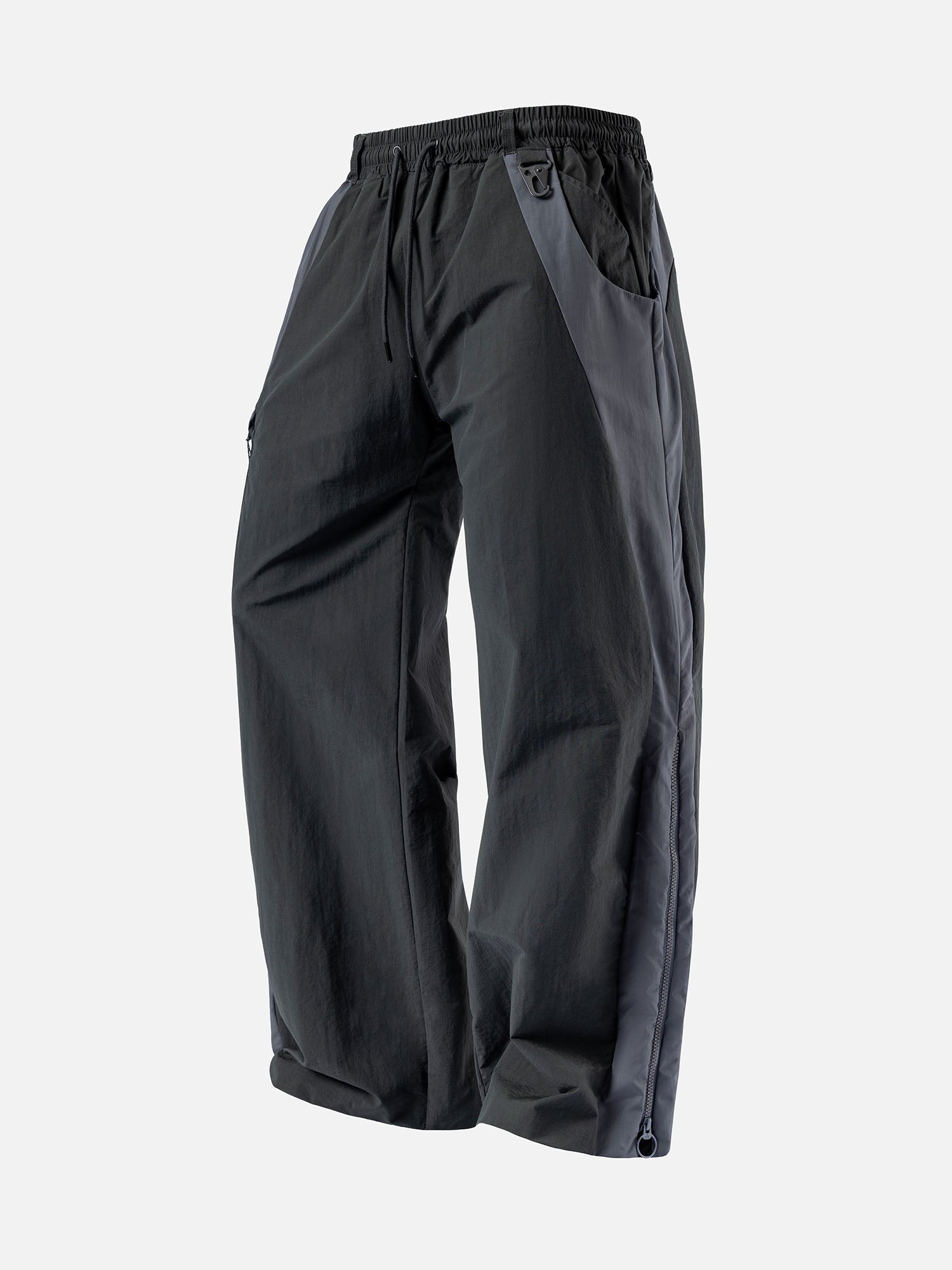 Charcoal with grey side panels track pants, featuring a decorative buckle at the waist, and a zip-up expandable seam to hem.