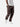 Side view of bark cargo pants with side pockets, ankle drawstrings, paired with a white t-shirt, and white sneakers.