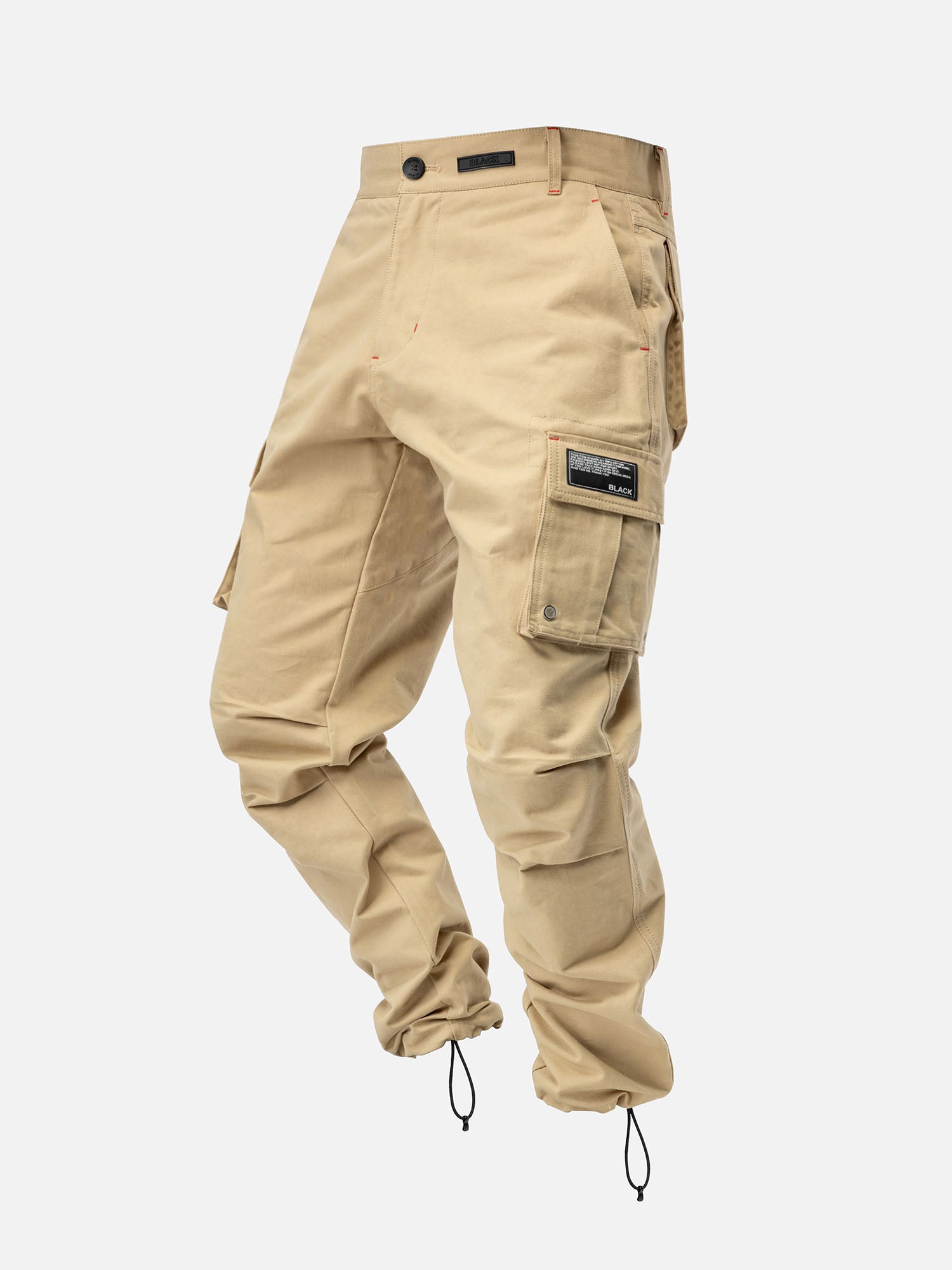Khaki cargo pants with red stitching, side pockets, and ankle drawstrings, with a modern streetwear look.