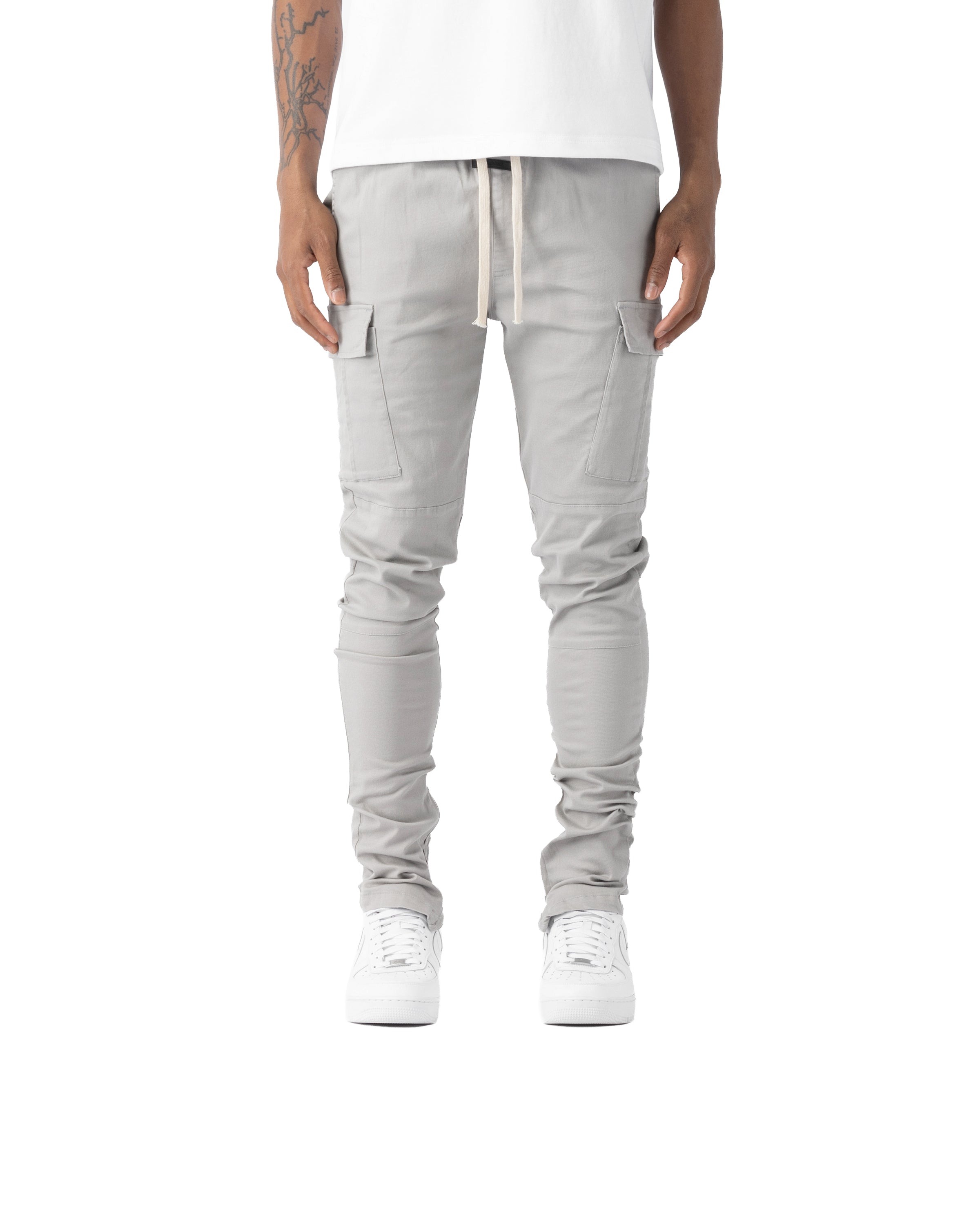 Person wearing light gray cargo pants on a white background