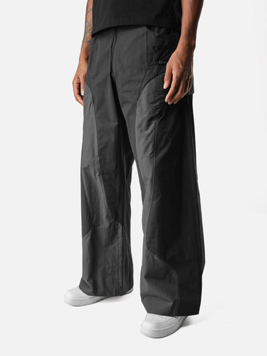 Black W7 Trackpants, casual half-body pose on model